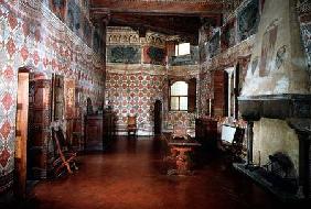 Bedroom or Sala dei Pavoni with frescoed trompe l'oeil decoration of wall hangings and a frieze of b