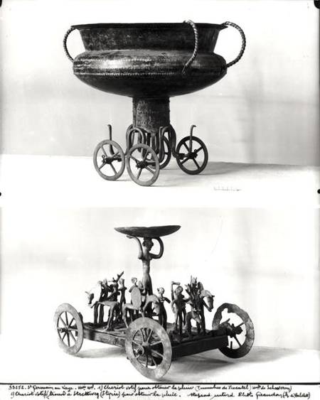 Two votive chariots for collecting rainwater: Top - cup supported on four wheels from the Peccatel t od Bronze  Age