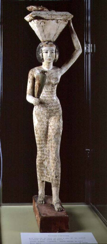 Female bearer of offerings carrying a water vase in her hand and a vessel on her head od Egyptian
