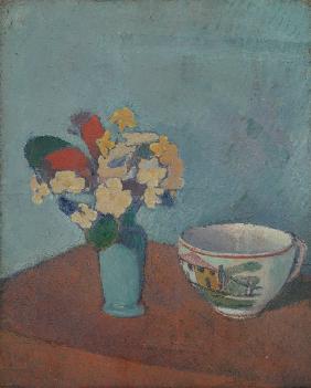 Vase with flowers and cup