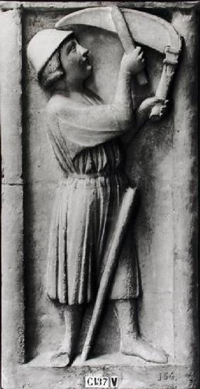 Peasant sharpening his scythe for the haymaking, representing the month of June, from the Portal of