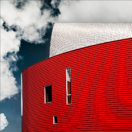 Three tiny windows in red wall