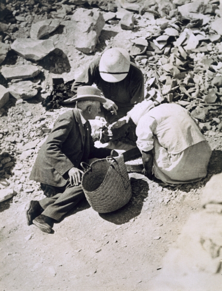 Sir Charles Cust (in soft hat) the King''s Equerry, with Mr Callender sifting the dust from the floo od Harry Burton