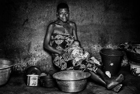 Woman and her chil in their home - Benin