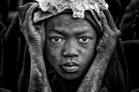 Surmi tribe child with an animal bone in his head.