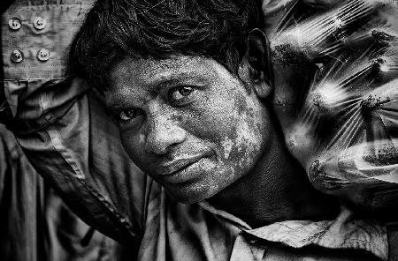 Carrying cucumbers at a market in Dhaka - Bangladesh