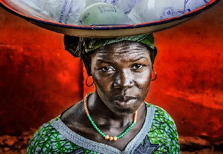 Selling water in a market in Benin.