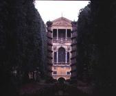 View of the rear facade from the woods framed by the two mosaic 'Columns of Hercules' designed for C