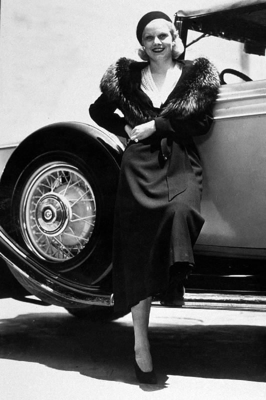American Actress Jean Harlow posing near a car od 