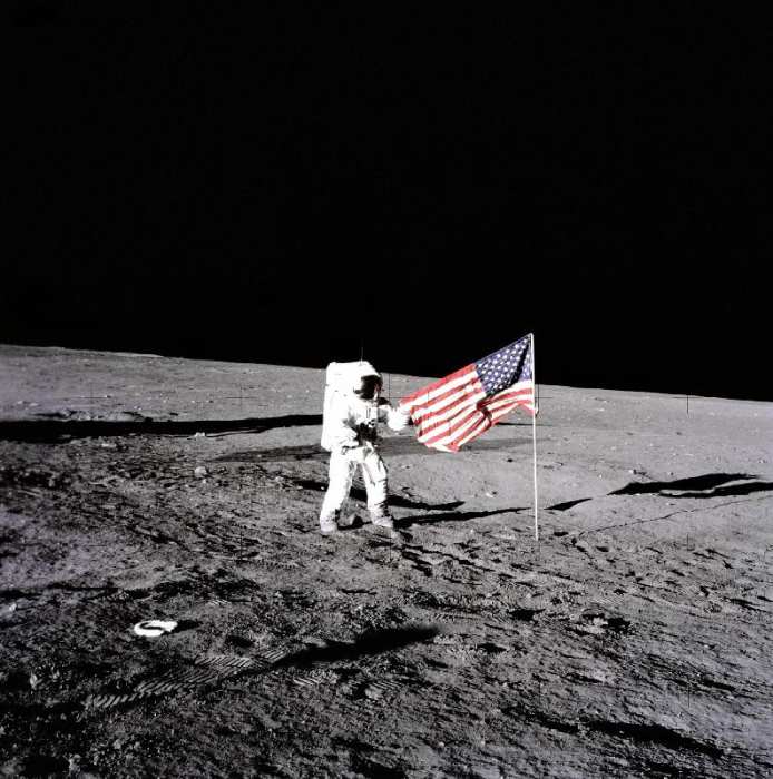 Apollo 12 Astronaut Charles Pete Conrad stands beside the United States flag after is was unfurled o od 