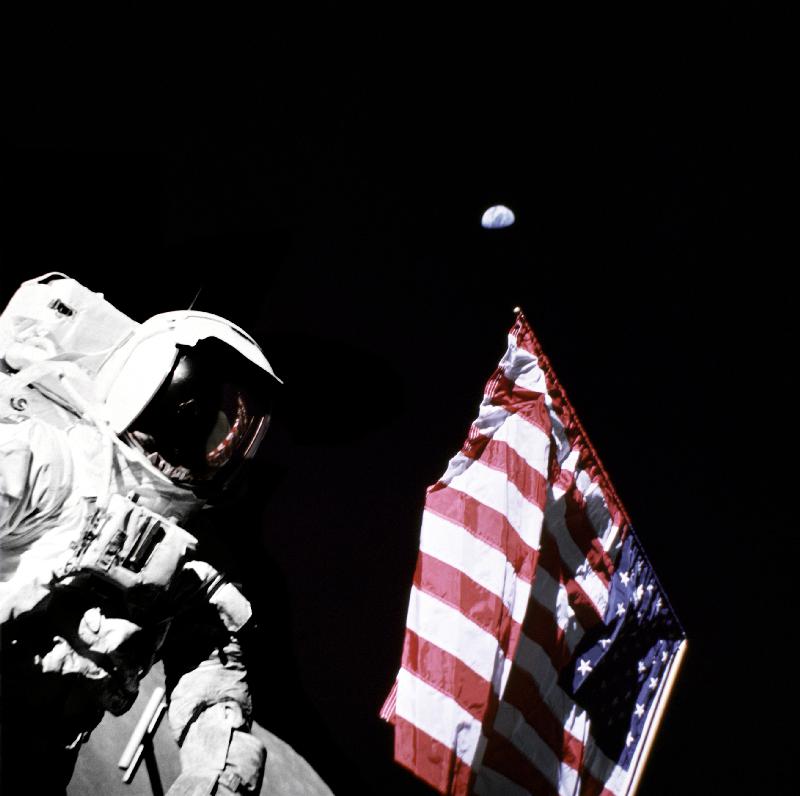 Geologist-Astronaut Harrison Schmitt, Apollo 17 Lunar Module pilot, is photographed next to the Amer od 