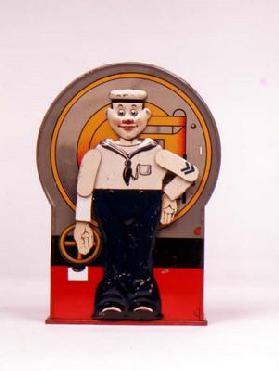 Tin Mechanical bank in form of a sailor. When the lever is depressed, he stands to attention and sal