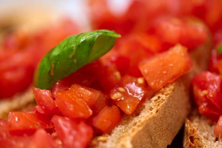 Bruschetta mit gewürfelten Tomaten und Baslikum.