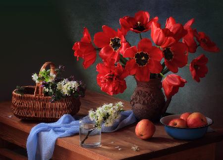 With a bouquet of red tulips